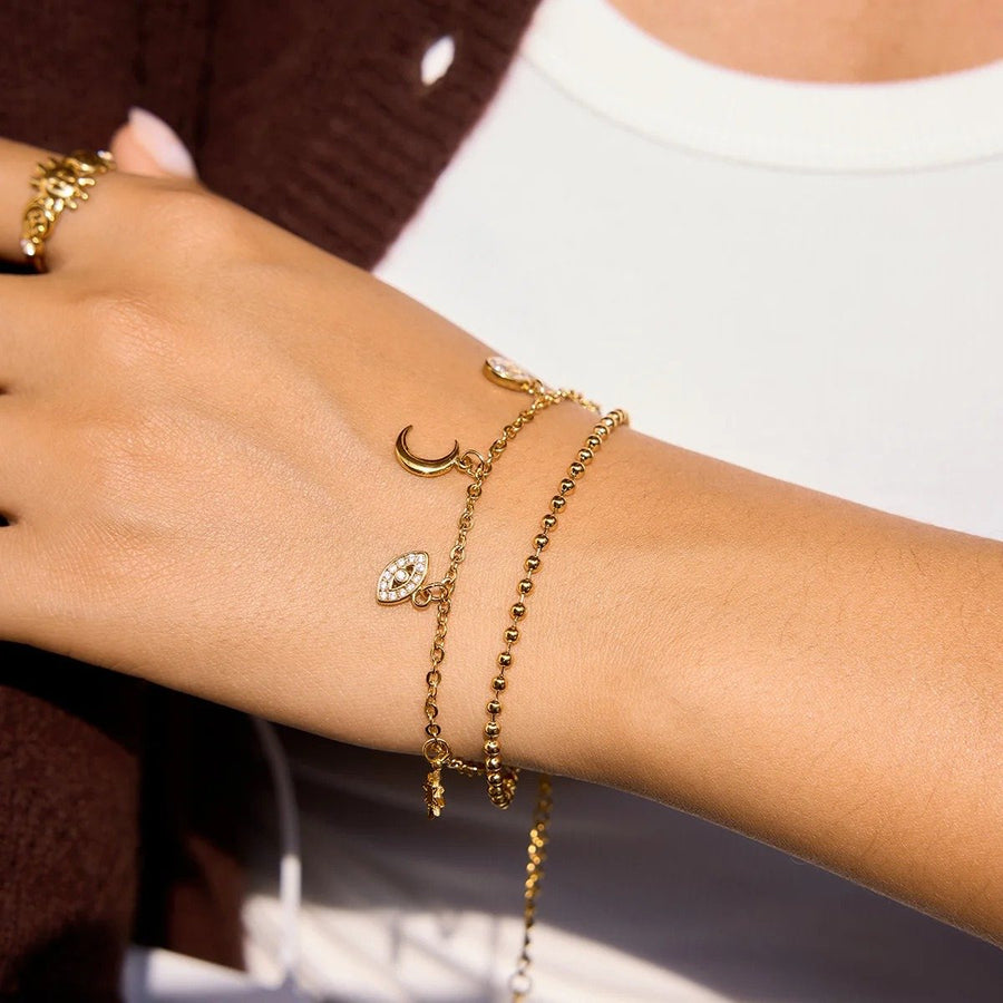 Eclipse Gold Charm Bracelet on the wrist, worn