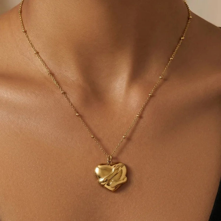 Embrace Gold Heart Necklace on the neckline, worn