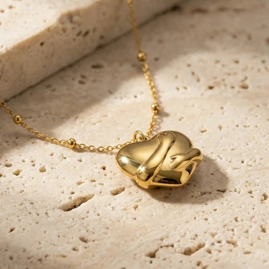Embrace Gold Heart Necklace, flat lay