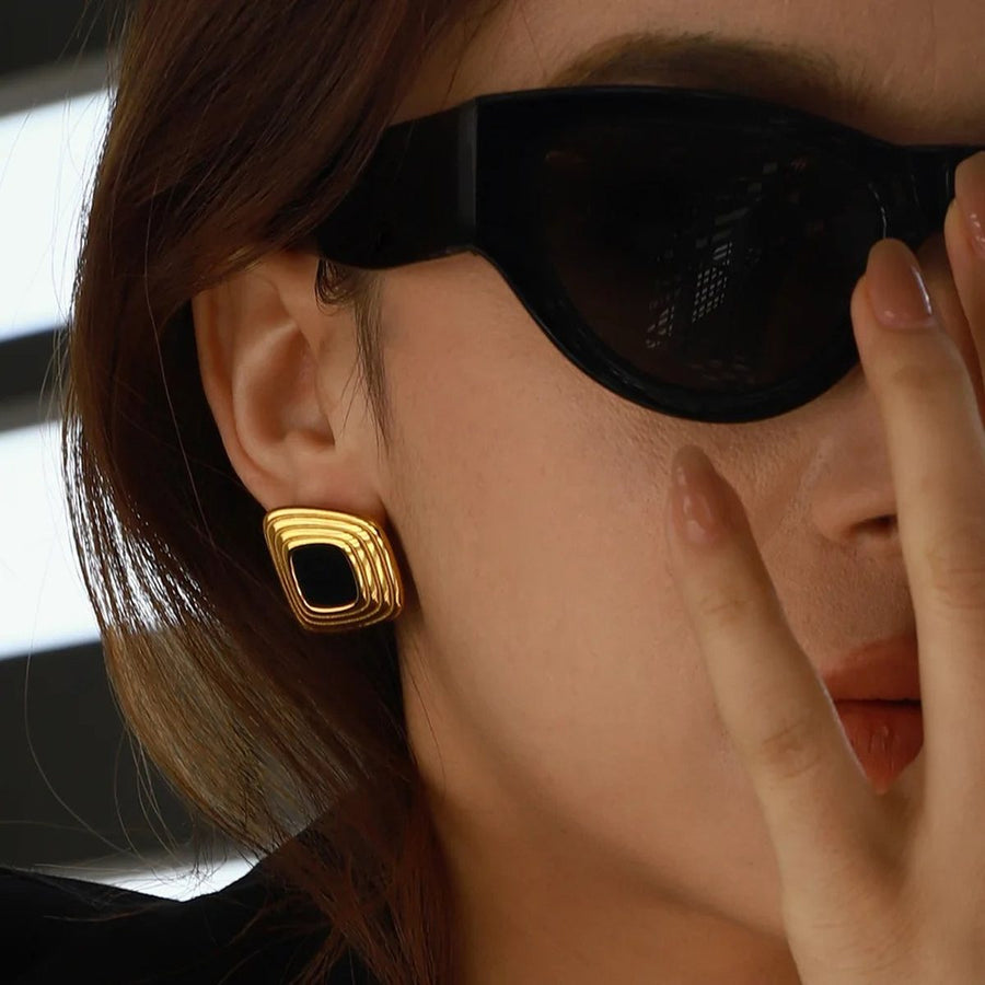 Nero Stepped Gold Stud Earrings on the ear, worn