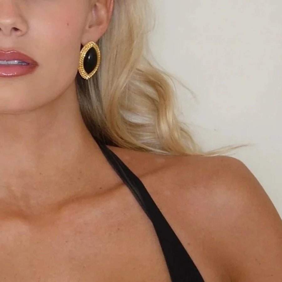 Noir Marquise Gold Stud Earrings on the ear, worn