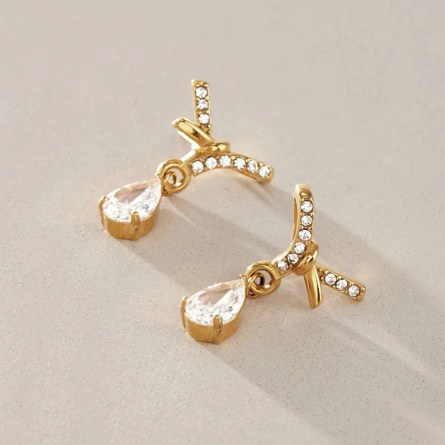 Noor Crossover Gold Teardrop Earrings, flat lay