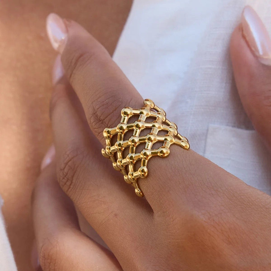 Treillis Mesh Gold Dome Ring on the hand, worn