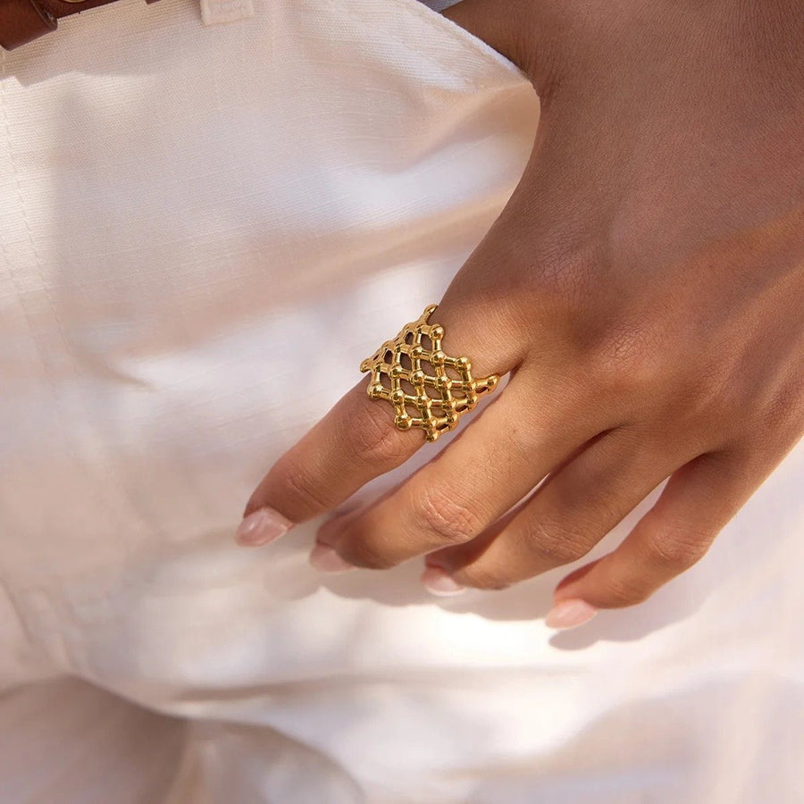 Treillis Mesh Gold Dome Ring on the hand, worn
