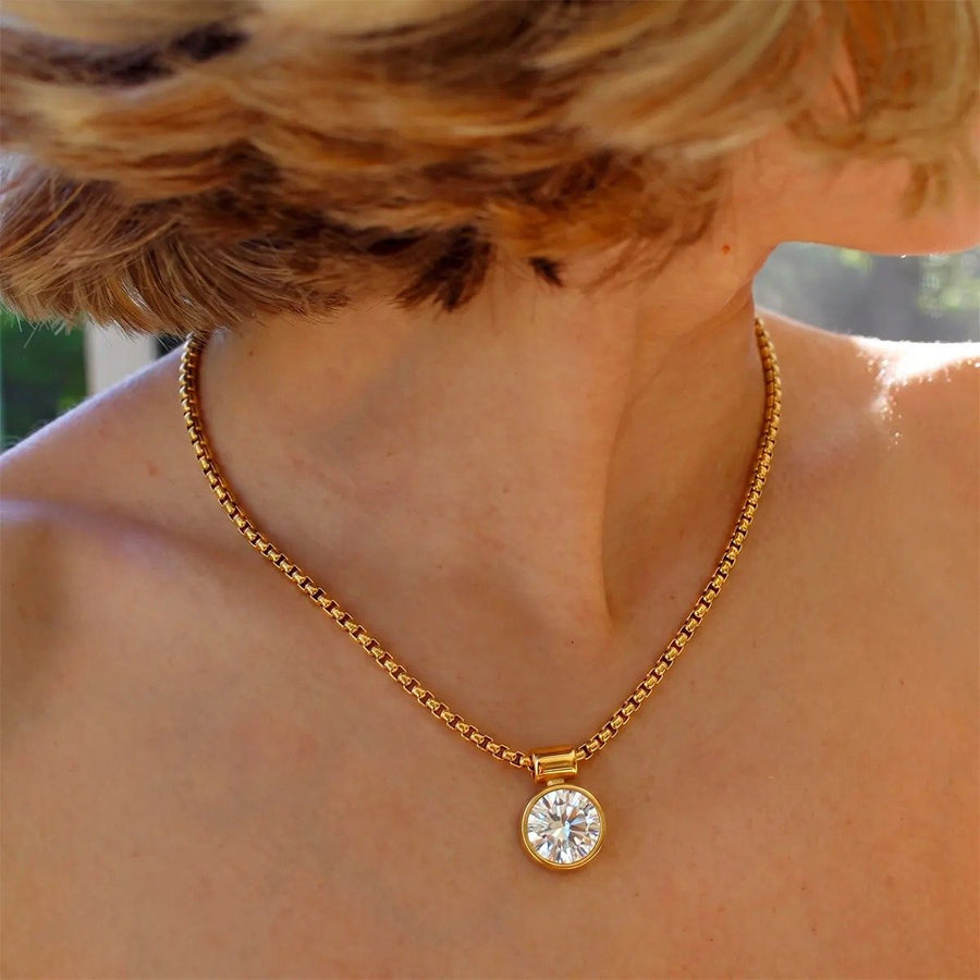 Cielo Solitaire Gold Pendant Necklace on the neckline, worn