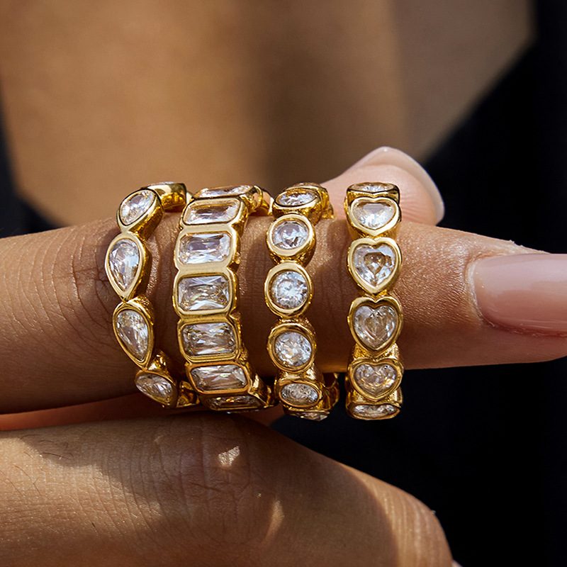 Eterna Heart Gold Stacking Ring, gold band of bezel-set heart and round stones
