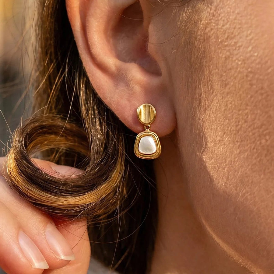 Marée Gold Pearl Drop Earrings on the ear, worn