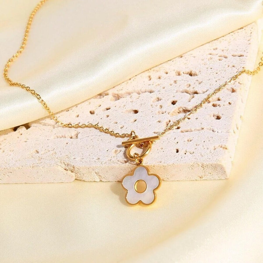 Marguerite Toggle Gold Flower Necklace, flat lay