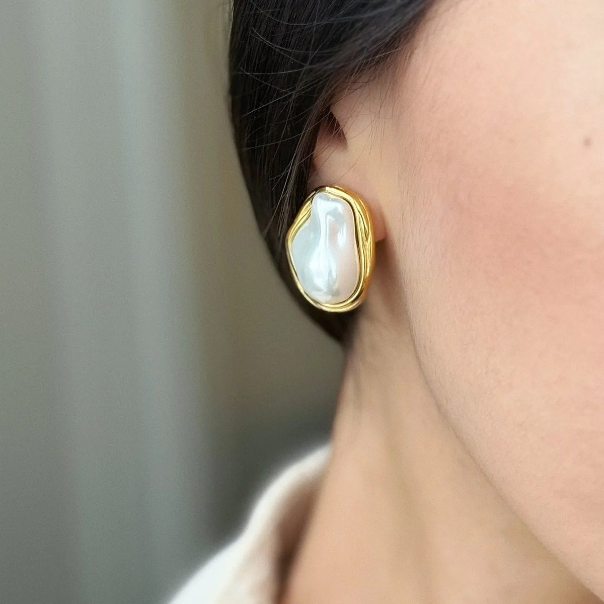 Nacre Baroque Gold Pearl Stud Earrings on the ear, worn
