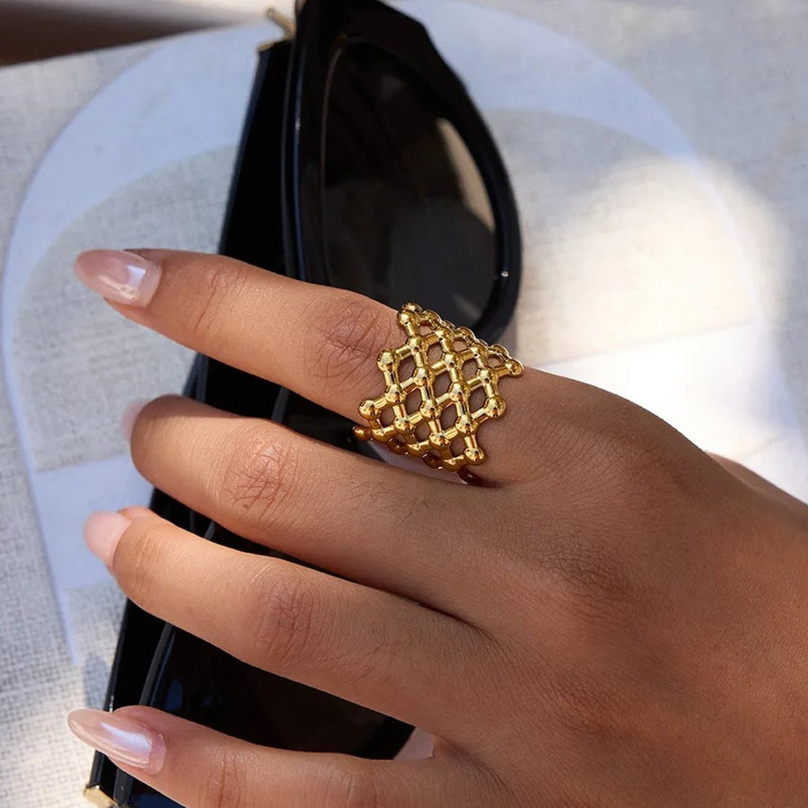 Treillis Mesh Gold Dome Ring on the hand, worn